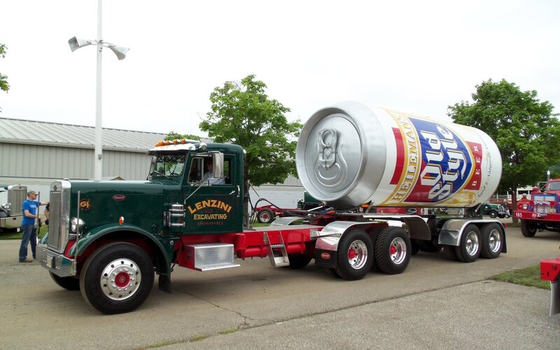 Green Peterbilt truck with beer can trailer