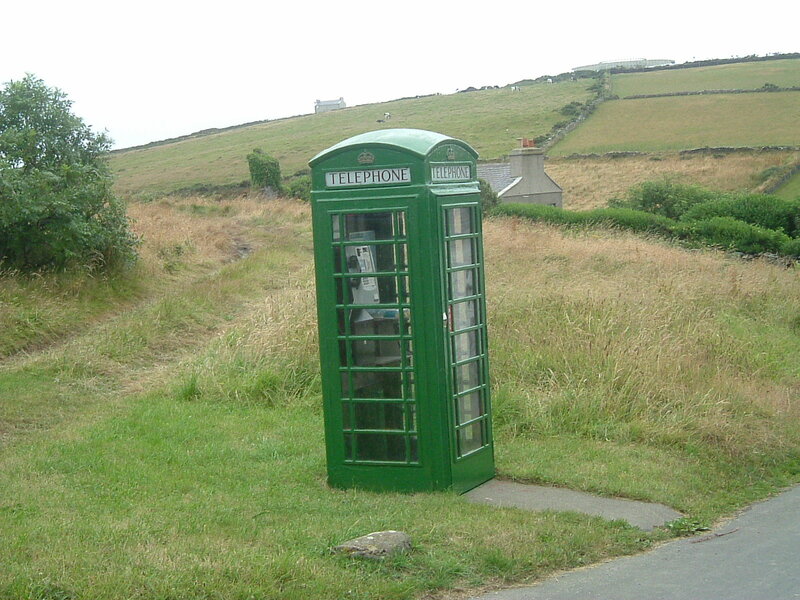 green phone booth in rural landscape