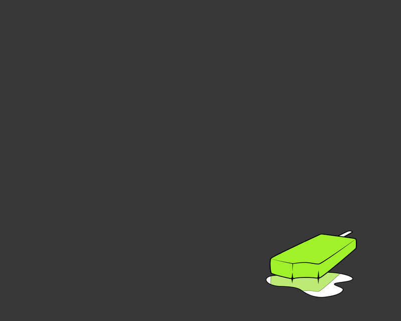 green popsicle on dark background