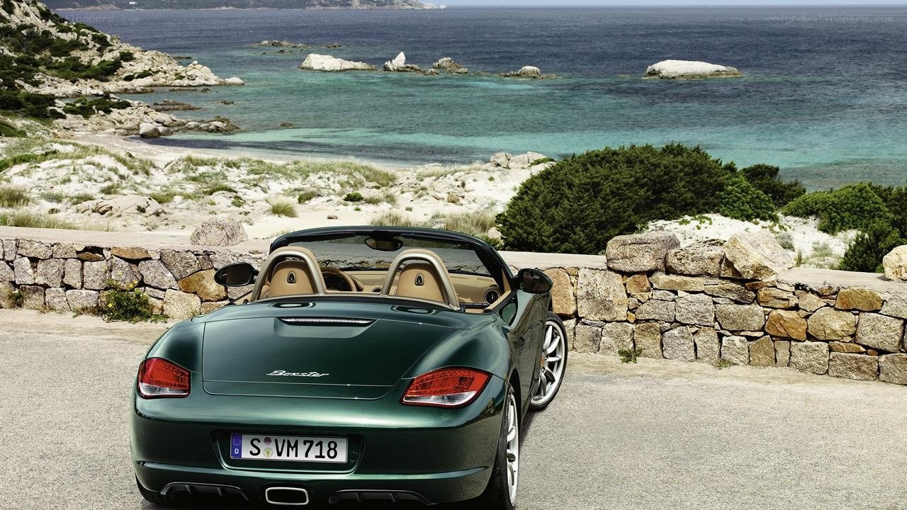 Green Porsche Boxster by the coast