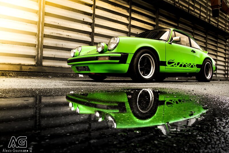 Green Porsche Carrera in puddle