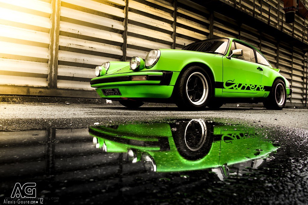 Green Porsche Carrera in puddle