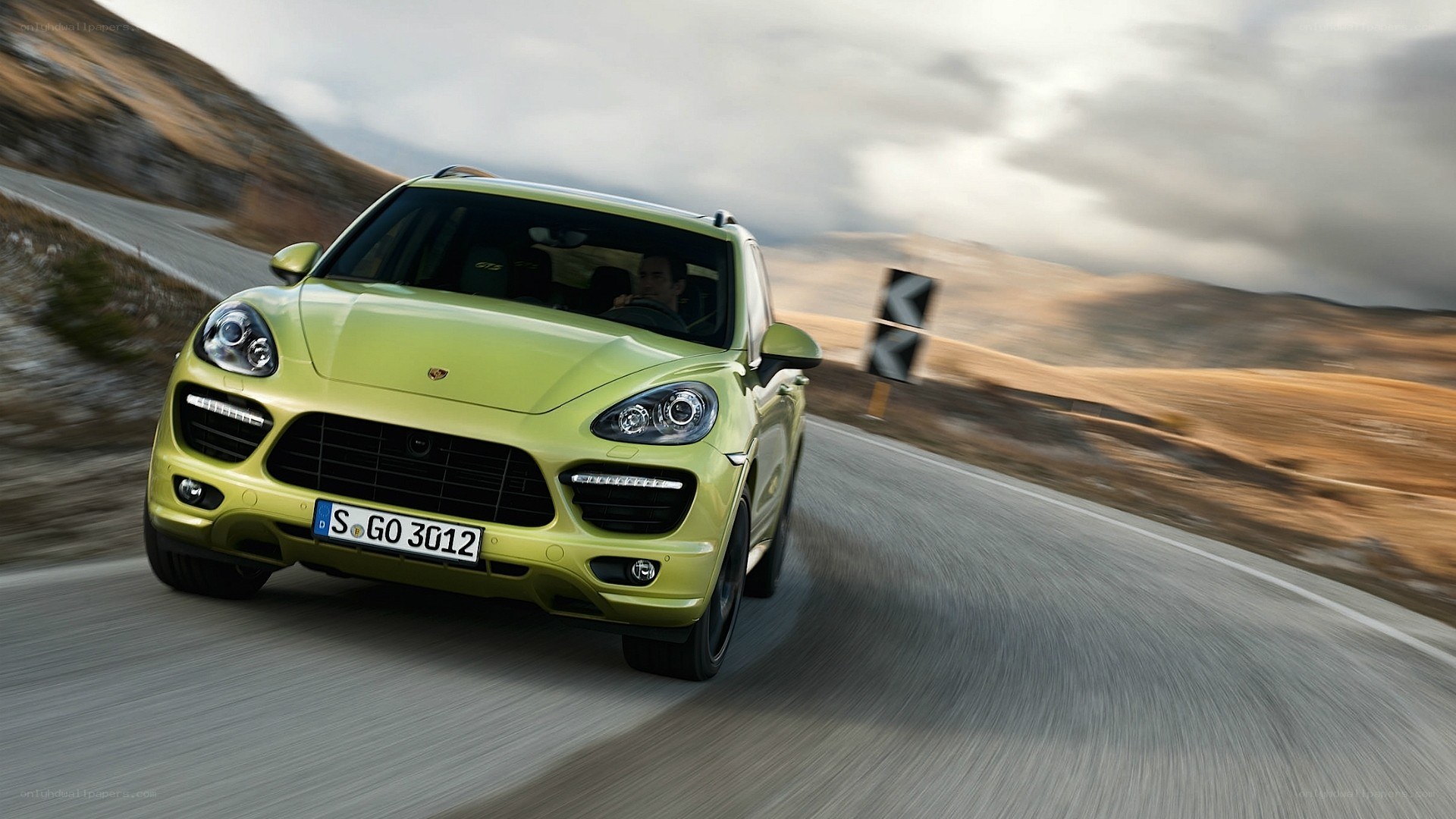 Green Porsche Cayenne in motion