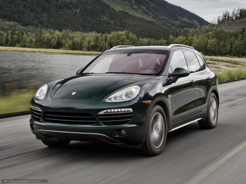 Green Porsche Cayenne on a scenic road