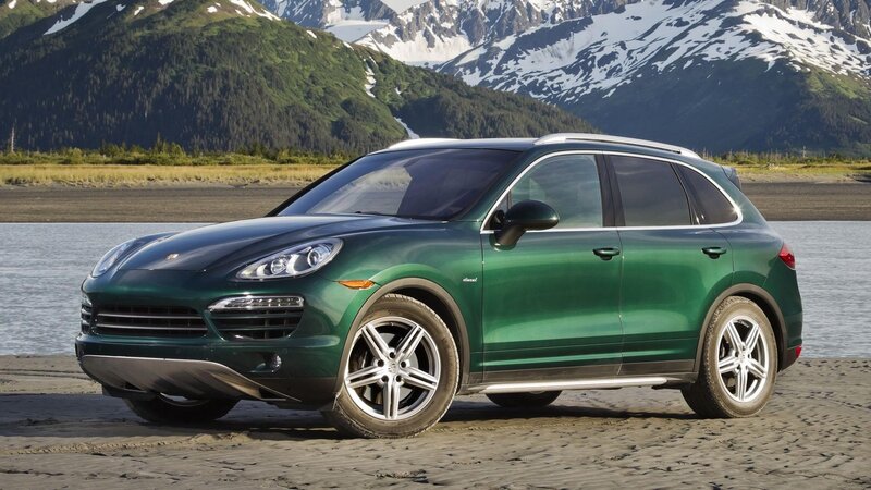 Green Porsche Cayenne on beach