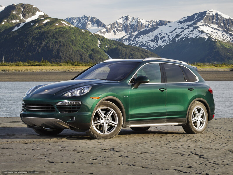Green Porsche Cayenne on beach