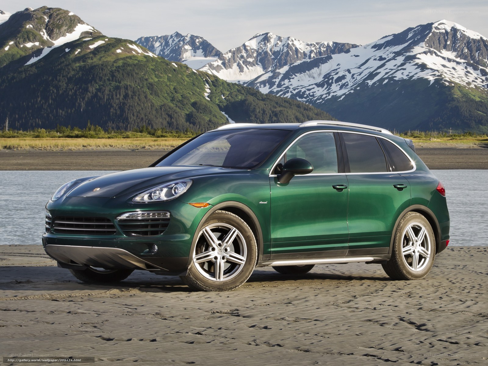Green Porsche Cayenne on beach