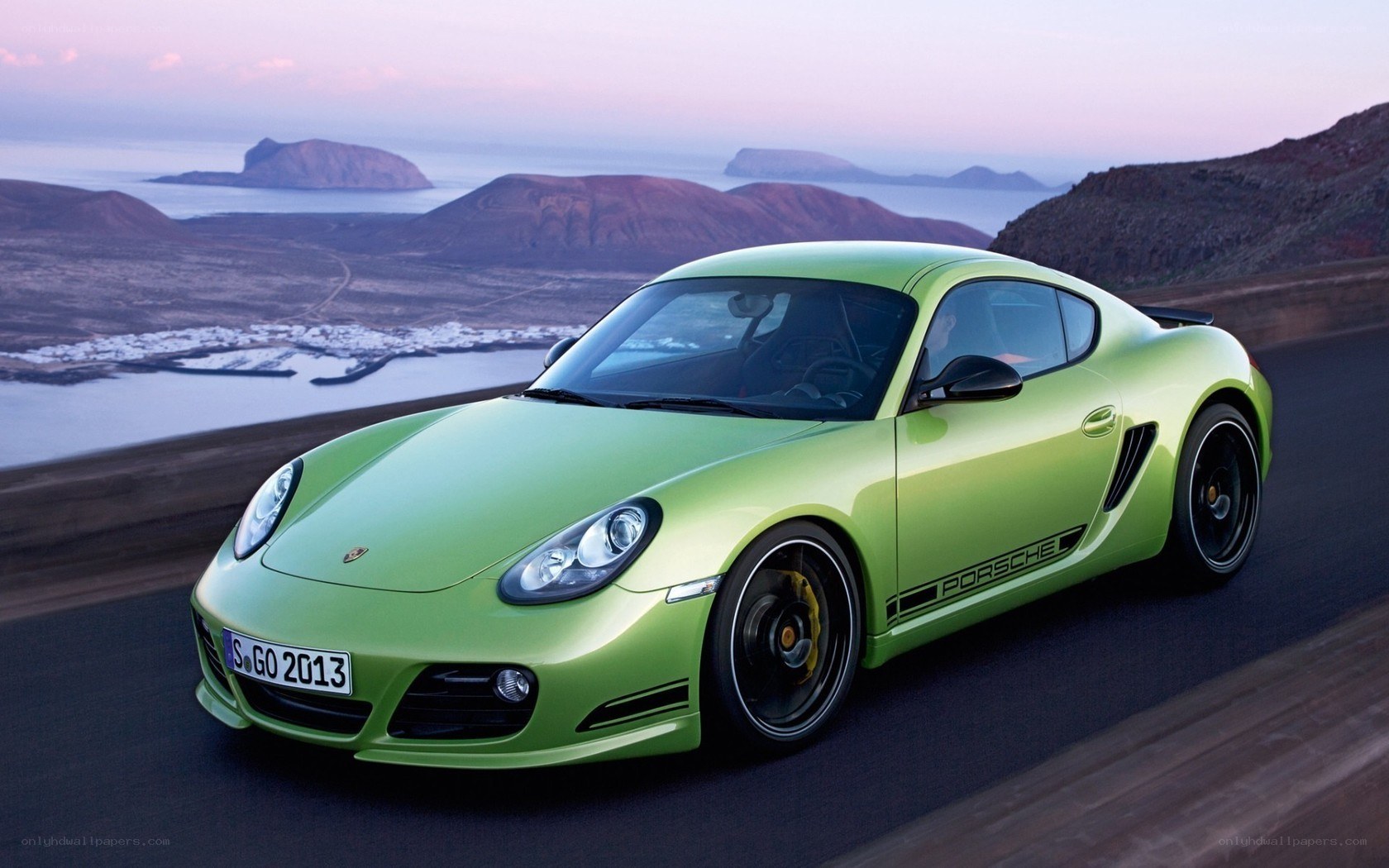 Green Porsche Cayman in scenic setting