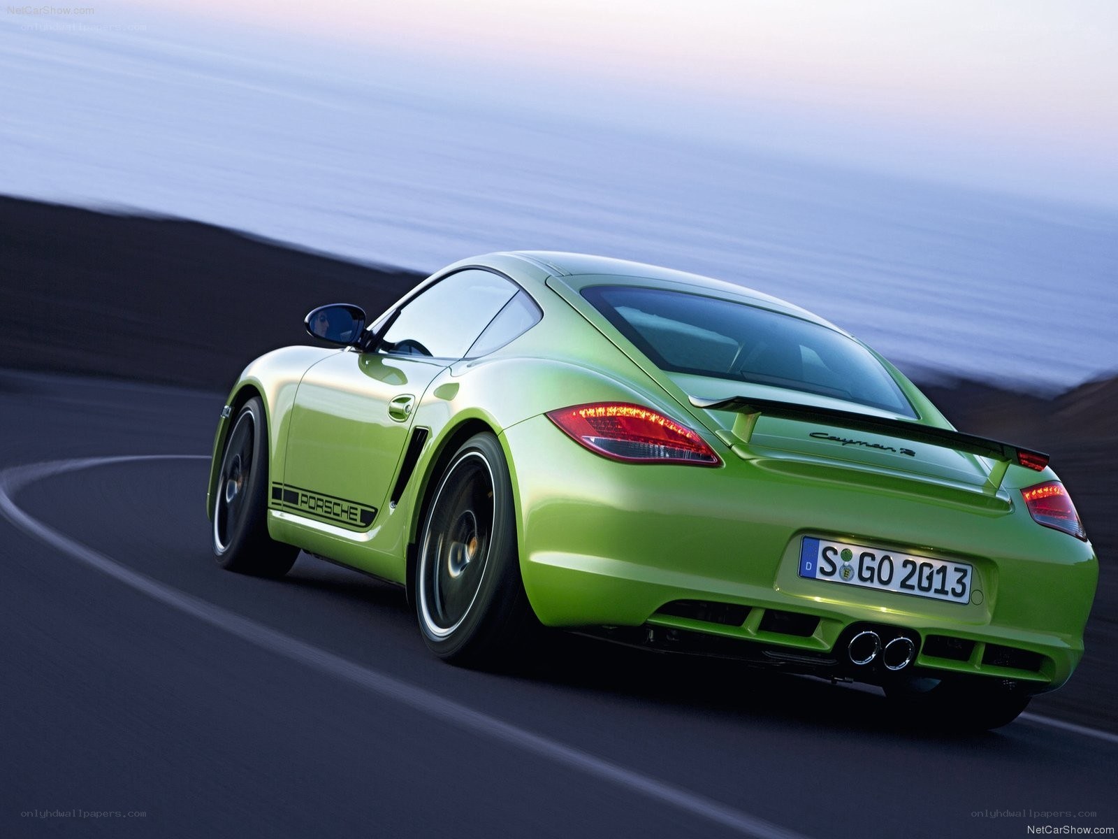 green porsche cayman s driving