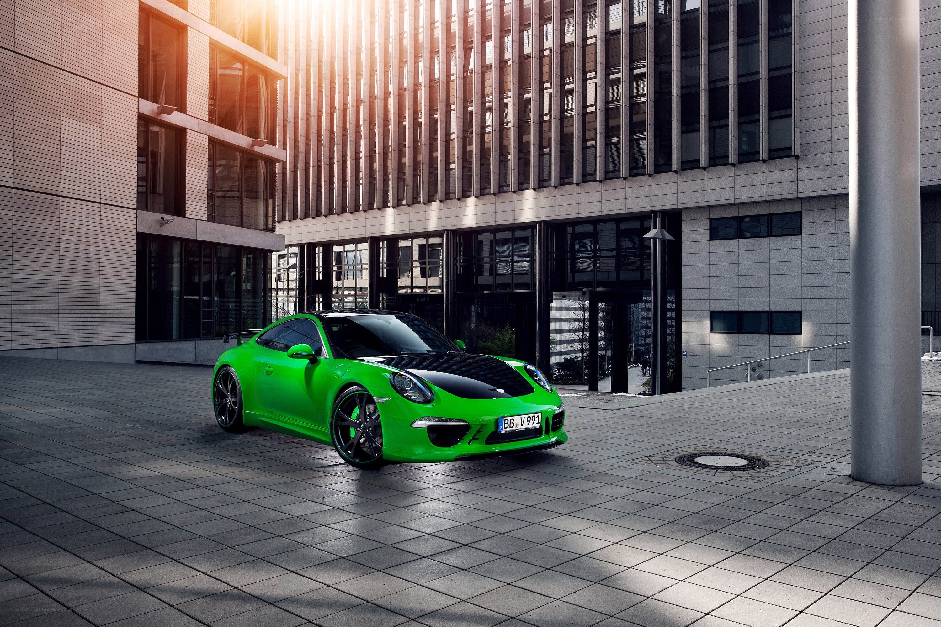 Green Porsche in urban setting