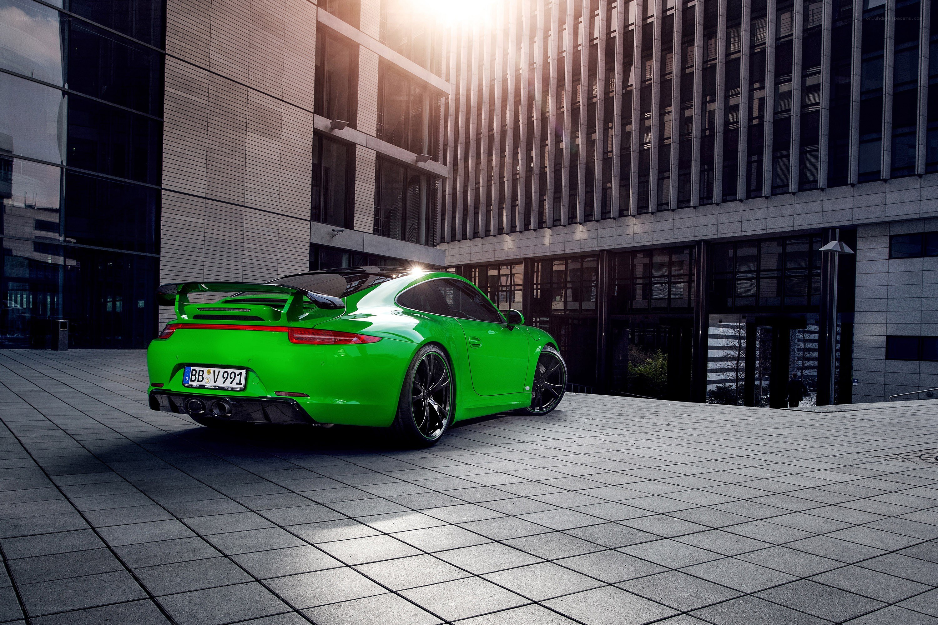 Green Porsche in urban setting