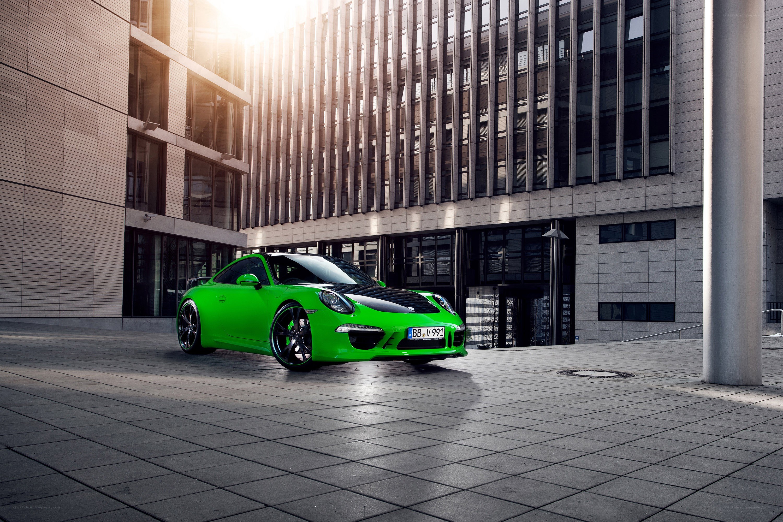 Green Porsche in urban setting