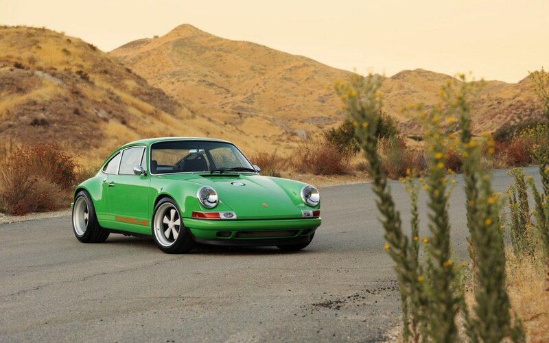 Green Porsche on a desert road