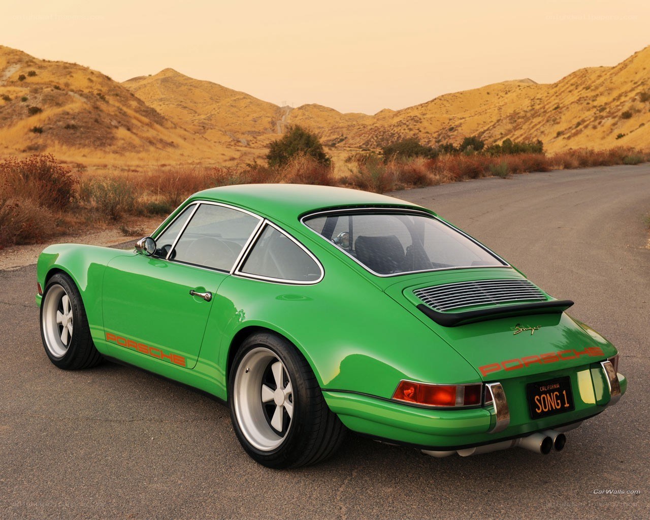 Green Porsche on a desert road