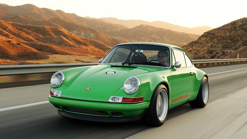 Green Porsche on a mountain road