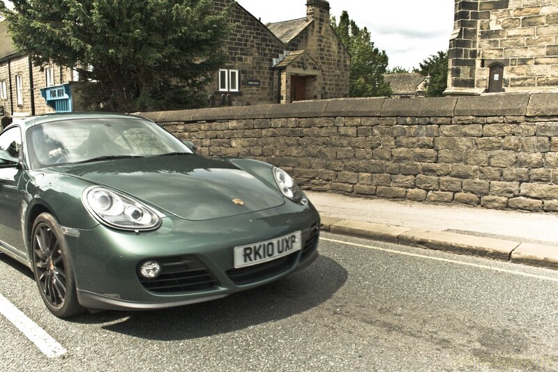 Green Porsche on a village street