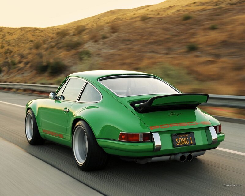 Green Porsche on a winding road