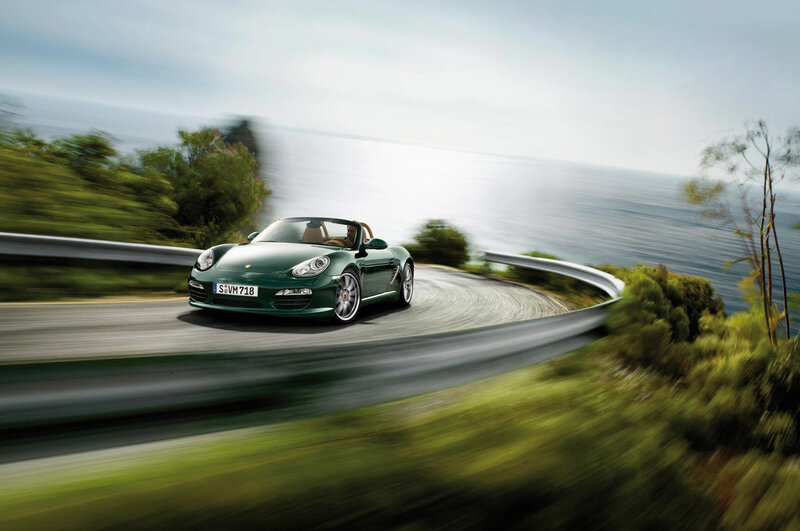 Green Porsche on coastal road
