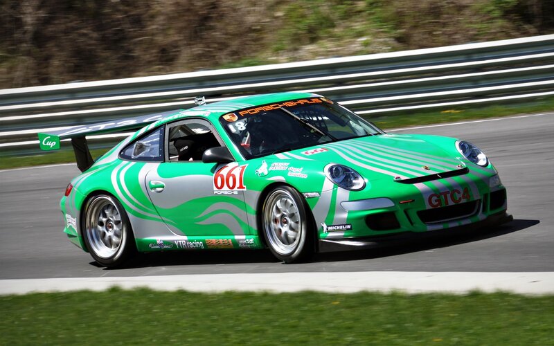 Green Porsche race car on track