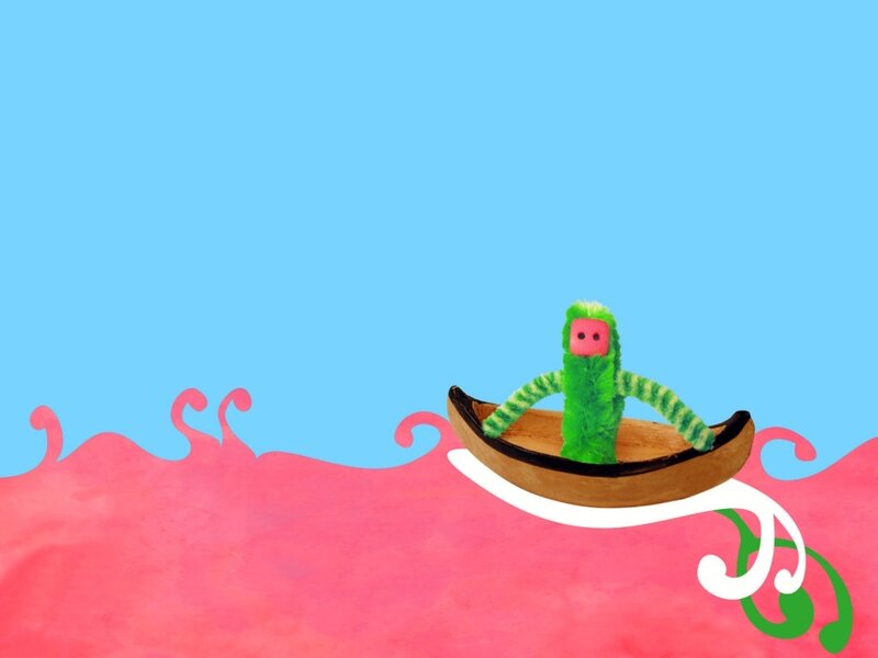 green puppet in a boat