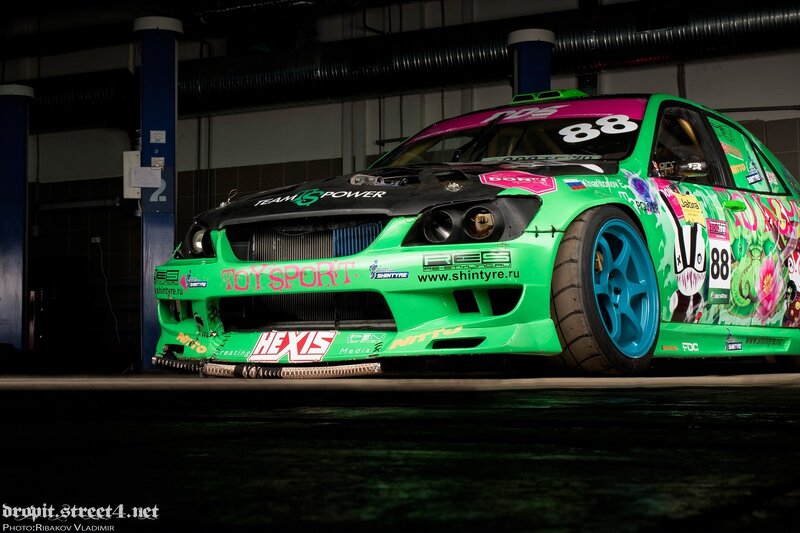Green Race Car — Dramatic, Night, Photograph, Tires