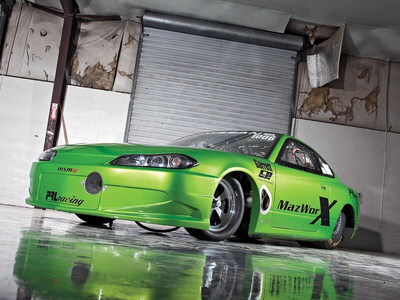 Green Race Car — Dramatic, Photograph, Garage, Roll-up Door