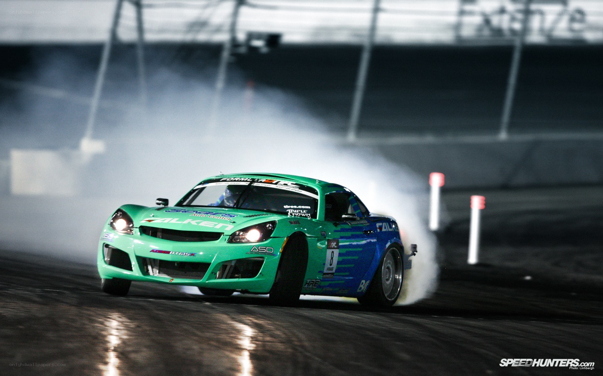 Green race car drifting at night