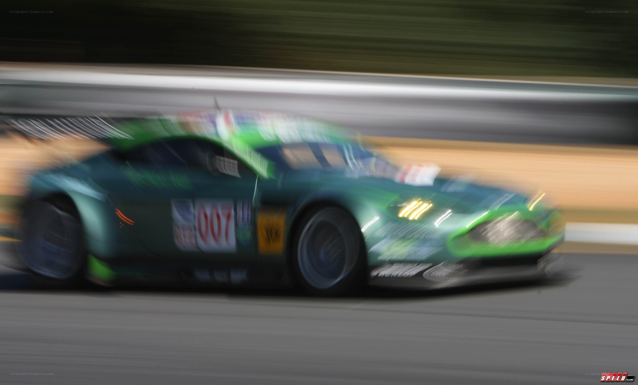 green race car in motion