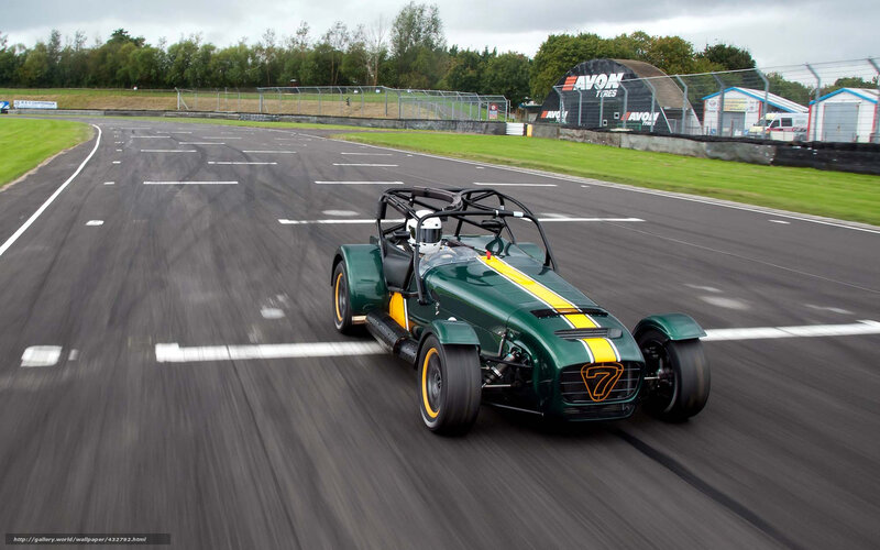 Green Race Car on Track — Dynamic, Afternoon, Photograph, Driver, Race Track, Tire Barriers