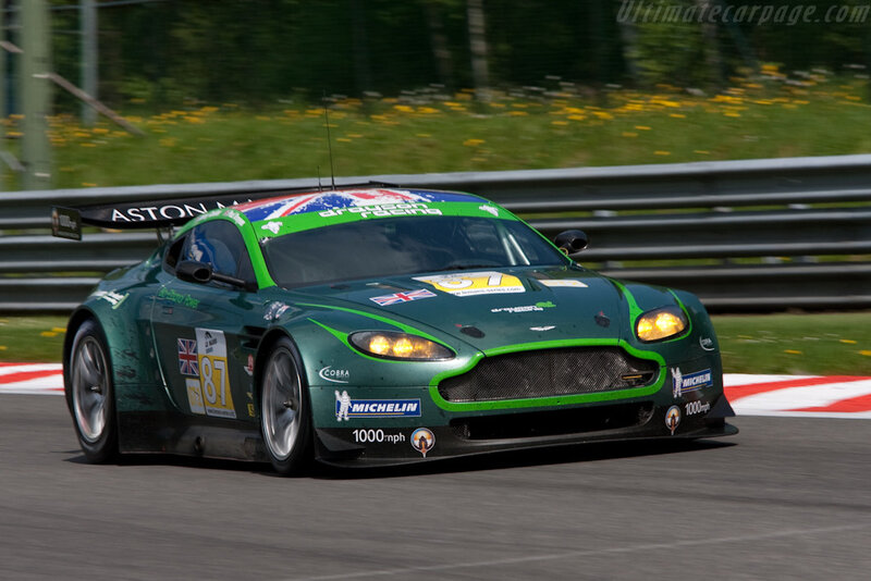 Green Race Car on Track — Dynamic, Afternoon, Photograph, Race Car, Grass