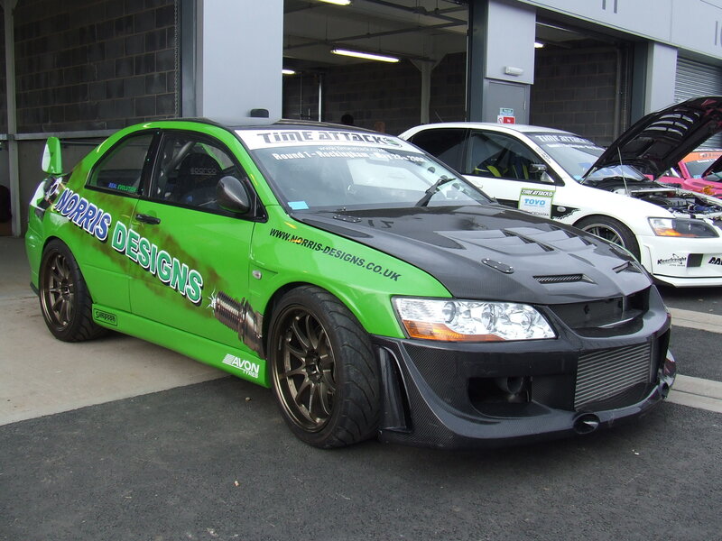 Green race car with sponsor decals
