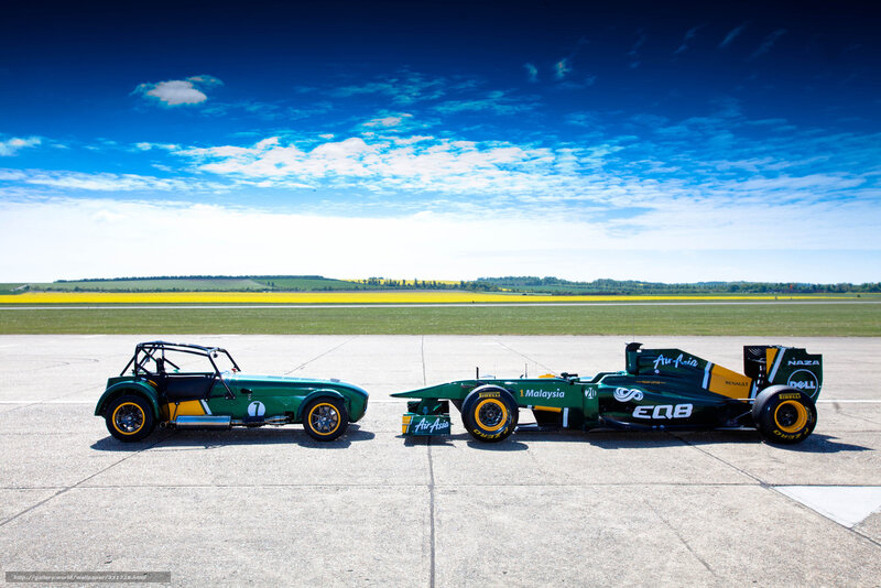 Green race cars on tarmac