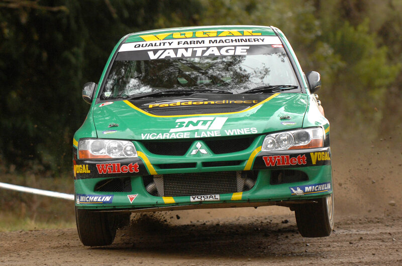 green rally car on dirt road