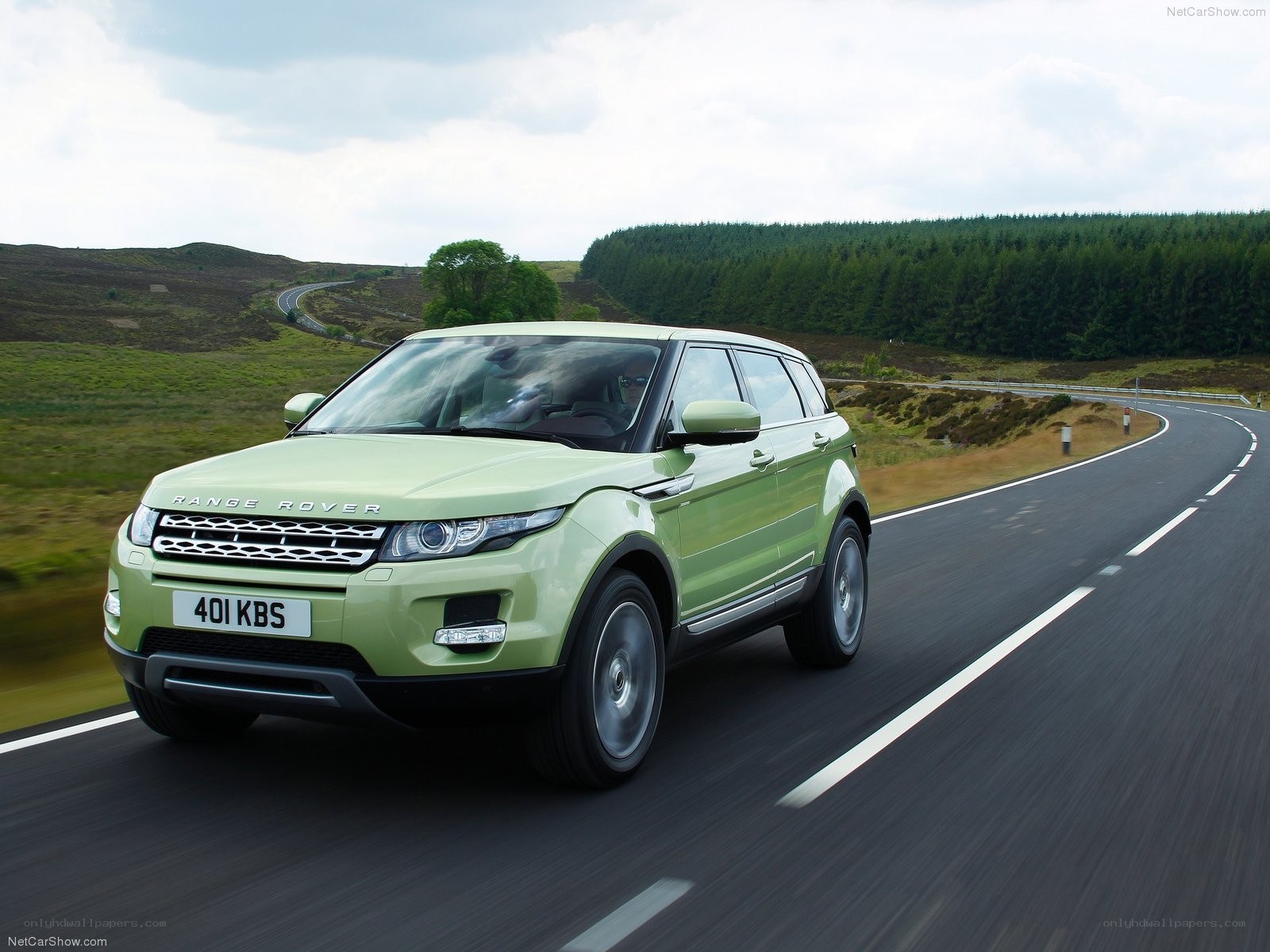 Green Range Rover driving on road
