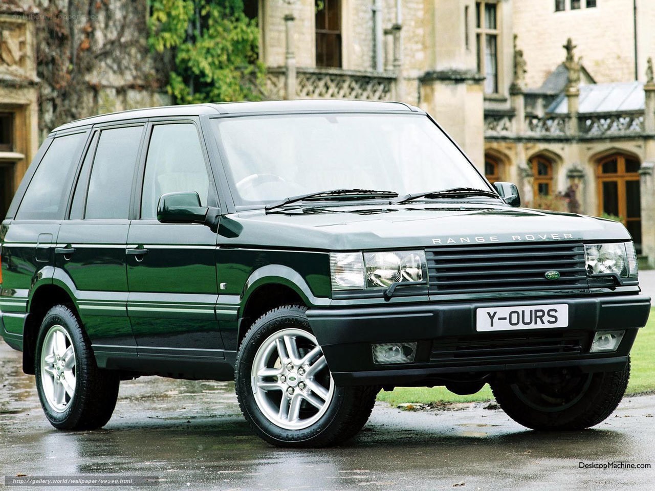 Green Range Rover in front of a building