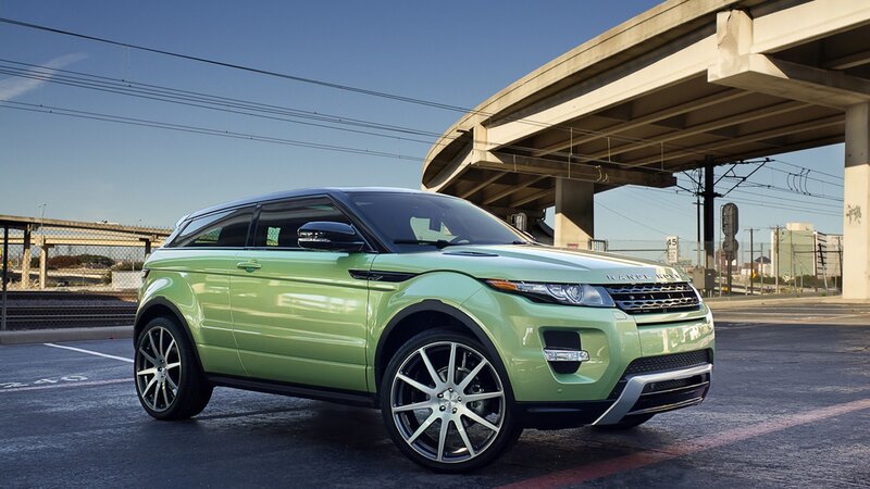 green range rover parked under overpass