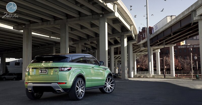 Green Range Rover under overpass