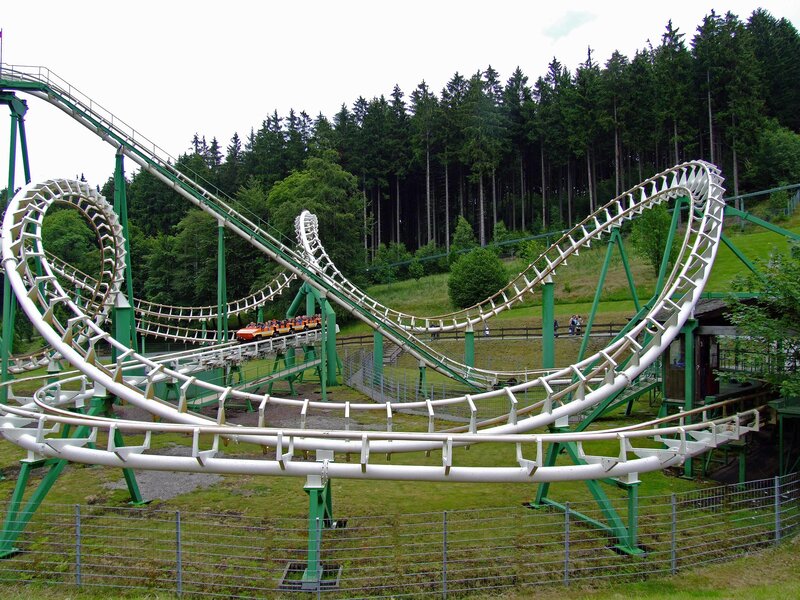 green roller coaster in forest