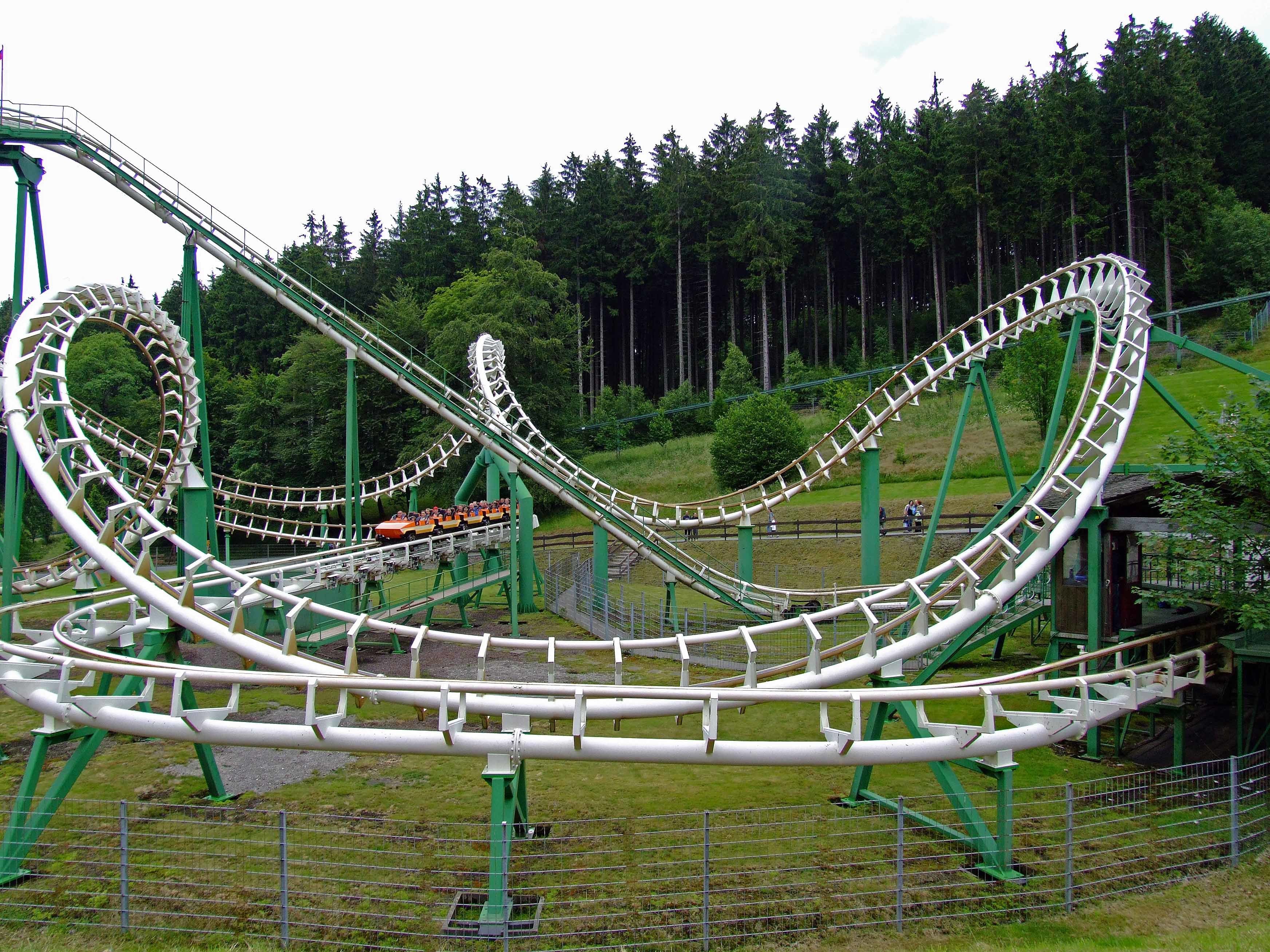 green roller coaster in forest