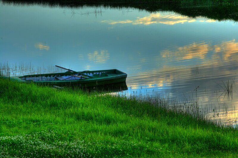 Green Rowboat on Shore — Serene