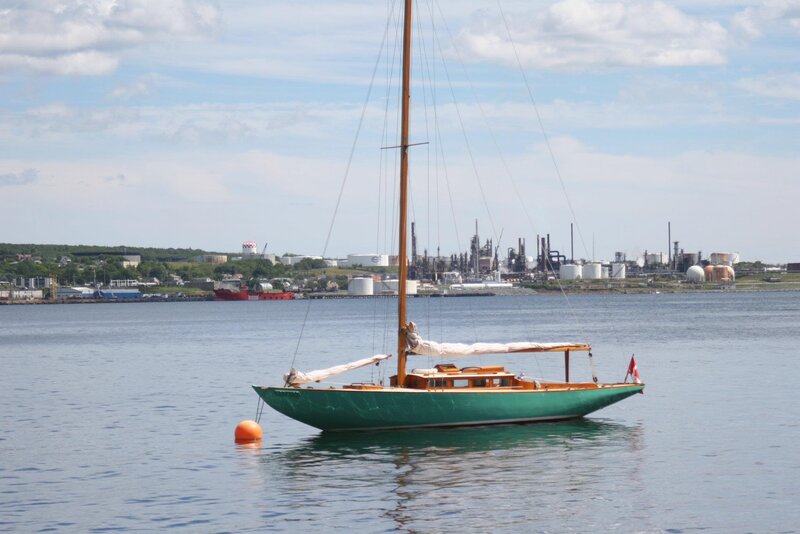 Green Sailboat in Harbor