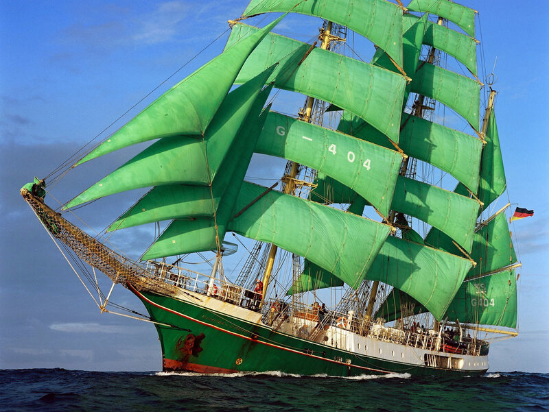 Green-sailed tall ship at sea