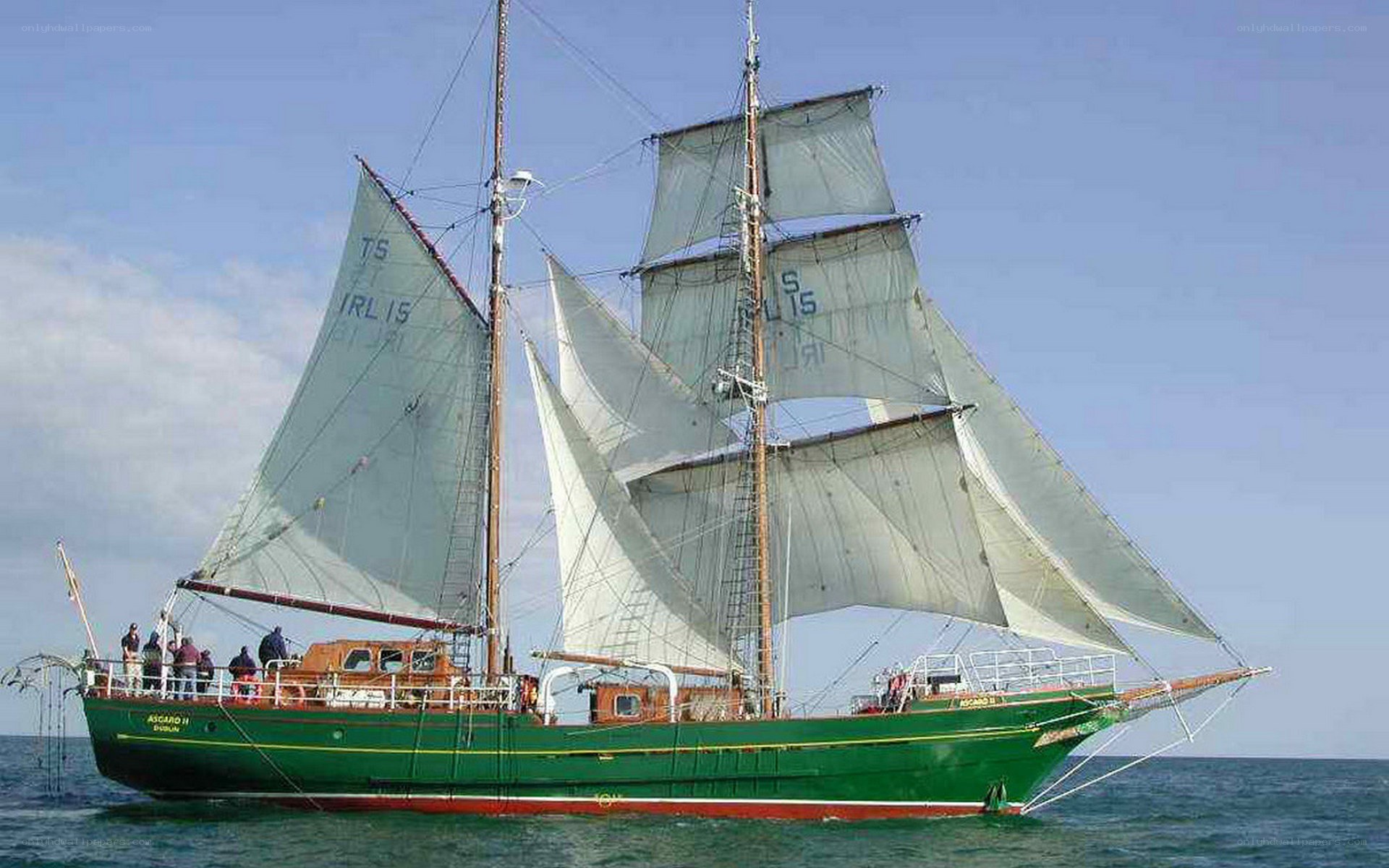 Green sailing ship at sea