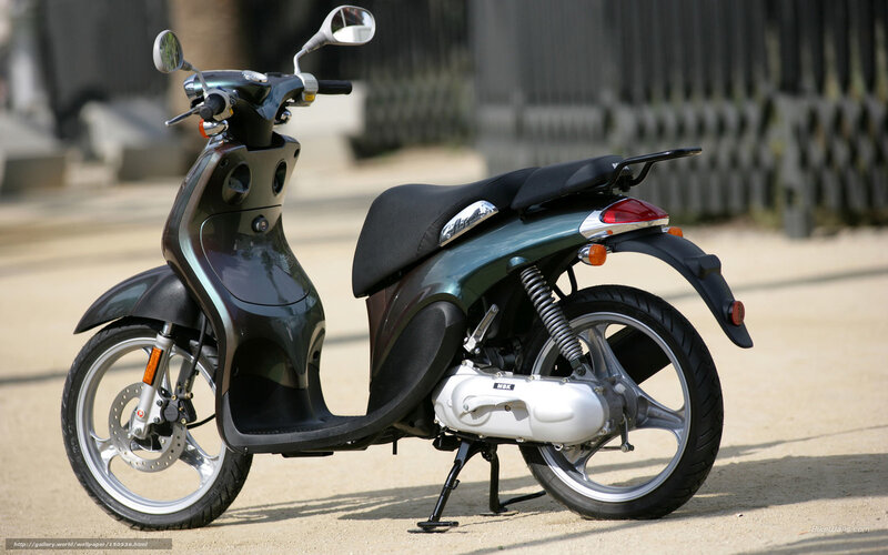 green scooter parked on street