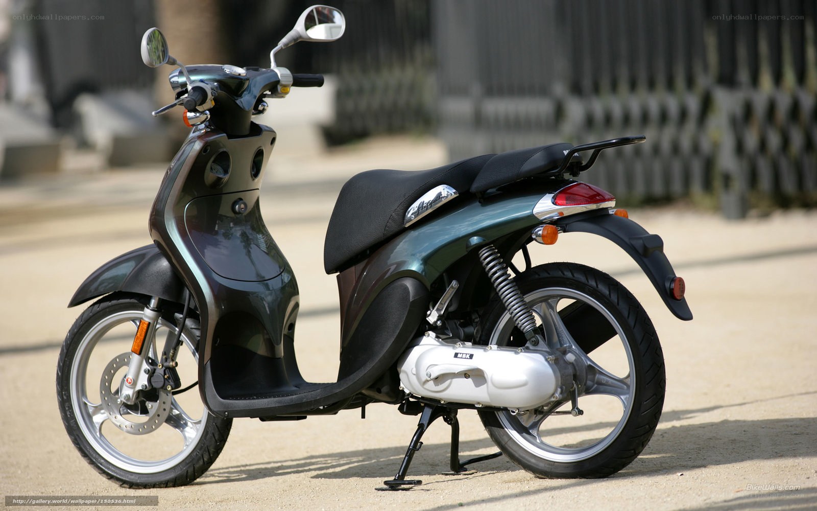 green scooter parked on street