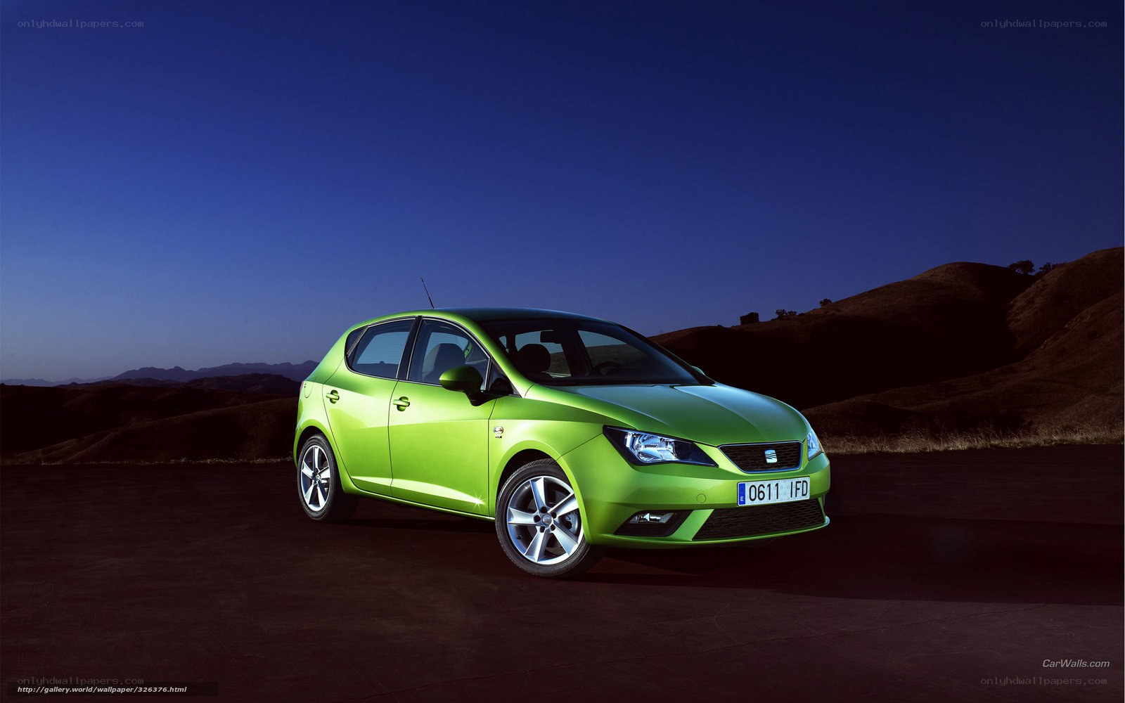 Green SEAT car on desert road