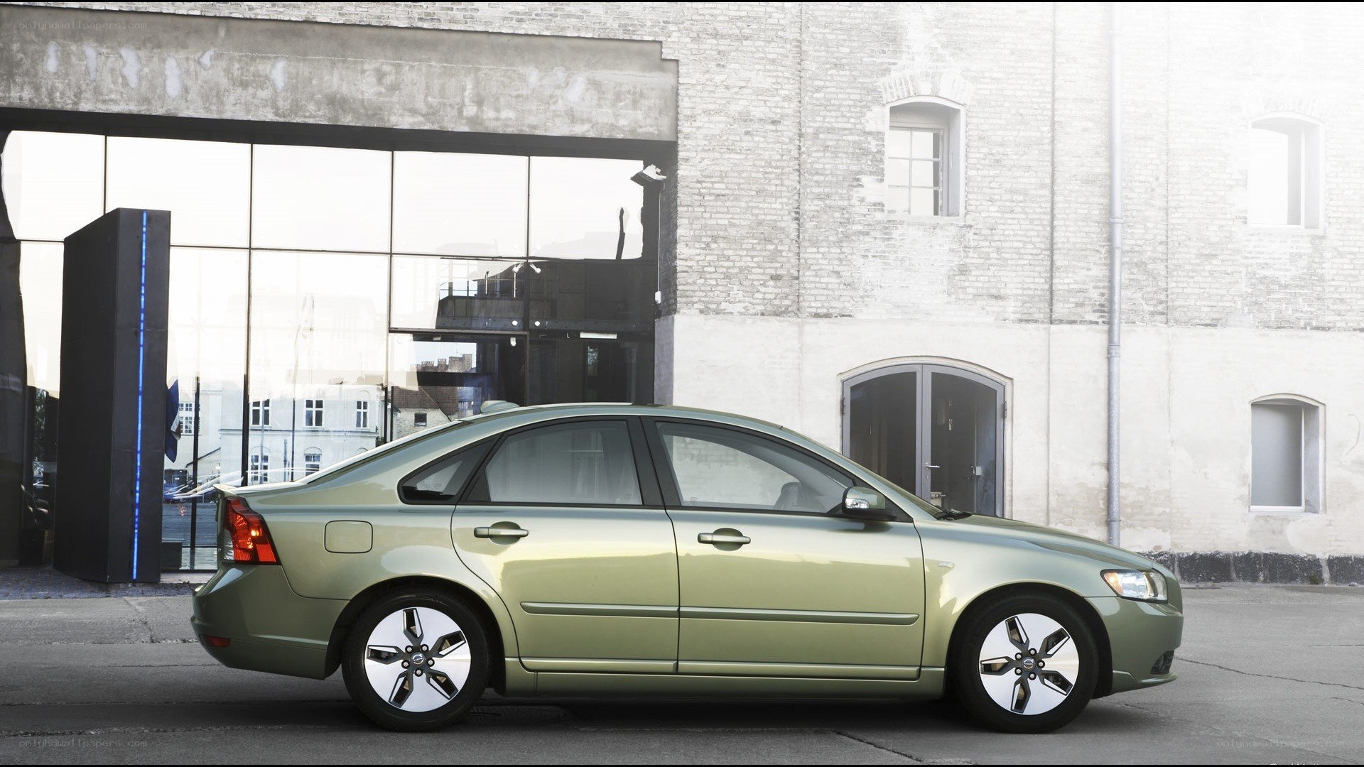green sedan in urban setting