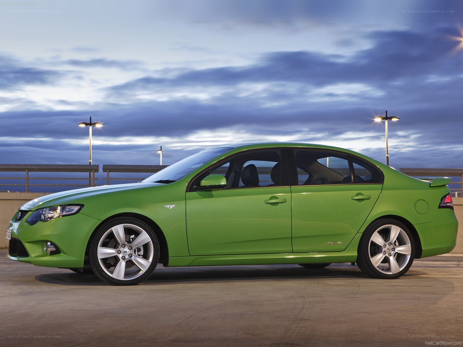 green sedan on a pier