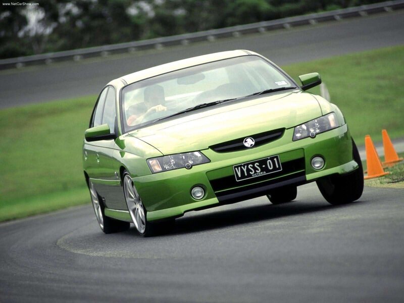 green sedan on a racetrack