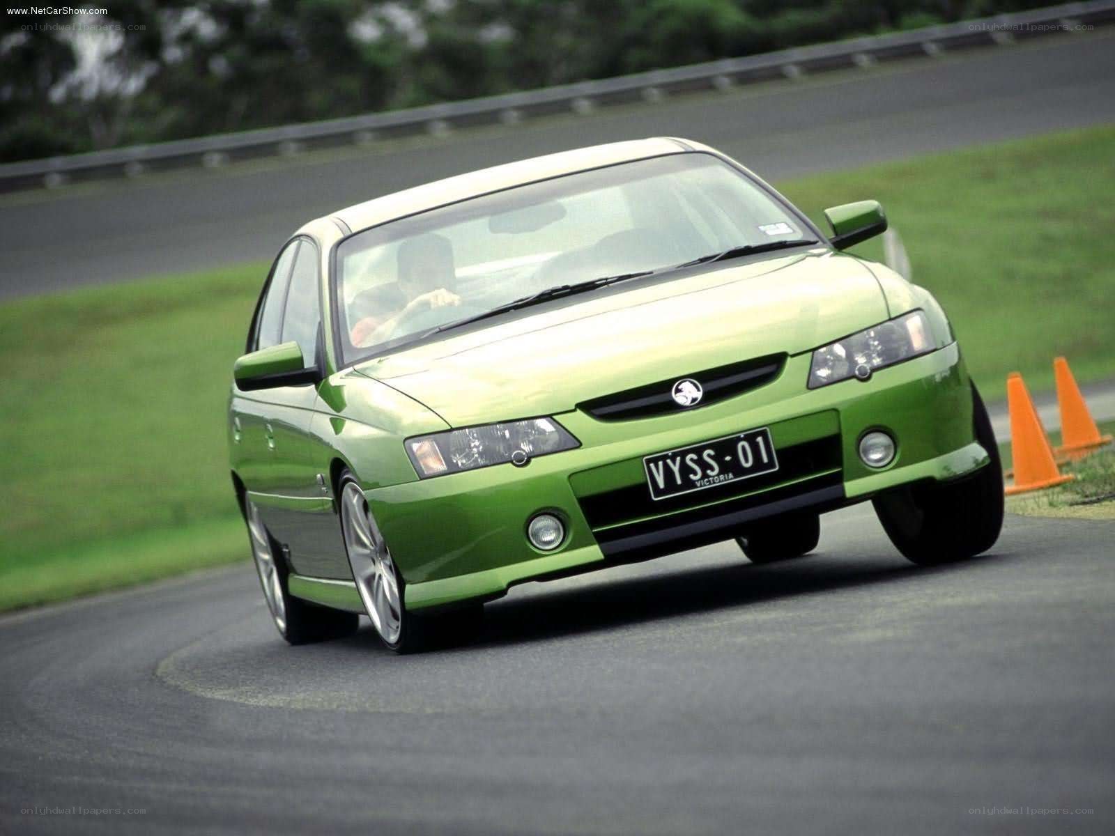 green sedan on a racetrack